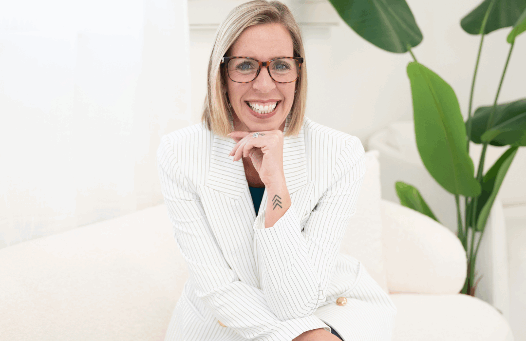 Kelly French sitting on a couch